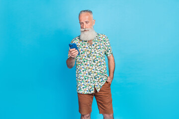 Poster - Portrait of focused aged person hold use telephone write typing isolated on blue color background