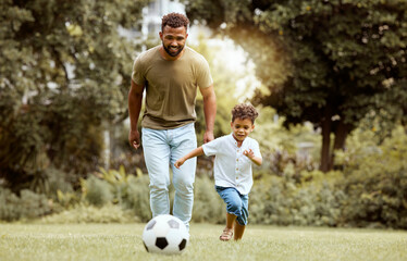 Wall Mural - Father, child and playing with soccer ball in the park for fun quality bonding time together in nature. Dad and kid enjoying family weekend, break or exercise for playful summer of soccer outside