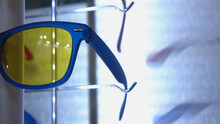 Close-up Of Sunglasses With Blue Frame And Yellow Lense. Fashionable Summer Wear.