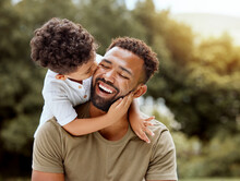 Father, Bonding Kiss And Boy Child Hug Happy In Nature With Quality Time Together Outdoor. Happiness, Laughing And Family Love Of A Dad And Kid In A Park Enjoying Nature Hugging With Care And A Smile