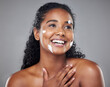 Skincare, beauty and face cream by black woman in studio mockup for wellness, hygiene and grooming. Black woman, facial and skin health by model smile, relax and enjoy treatment on grey background