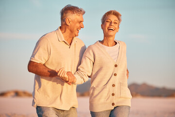 Wall Mural - Retirement, couple and being playful outdoor, walking or on beach being loving, together or happy marriage. Love, senior man and mature woman with smile, embrace and holding hands and seaside bonding