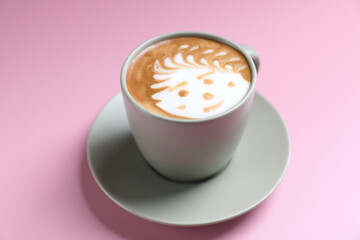 Wall Mural - hot cappuccino with latte art isolated in pink background