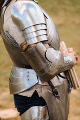 Close-up of a medieval knight in armor preparing for battle