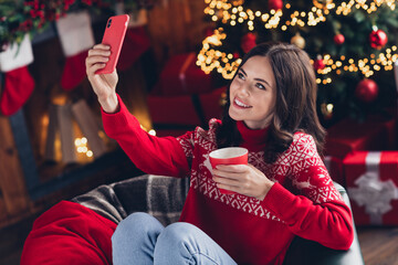 Sticker - Portrait of peaceful attractive lady sitting chair hold telephone make selfie enjoy hot coffee mug house indoors