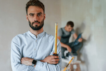 Two men is making repairs in the apartment together