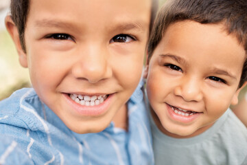 Poster - Family, face and portrait of brothers bond, relax and hug outdoors, having fun and playing together. Love, happy family and mexican boy embrace brother, happy and cheerful while enjoying free time