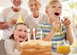 © Beaunitta V W/peopleimages.com - Happy birthday, family and girl with a cake in a party celebration with grandparents and excited sibling or brother. Smile, happiness and young child celebrates, laughing and enjoying a special day