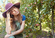 © J Maas/peopleimages.com - Apple, farming and woman farmer in orchard checking harvest, crop and fruit. Thinking, contemplating and thoughtful girl in apple orchard worried about farm, natural produce and agriculture business