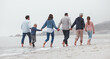 © Beaunitta V W/peopleimages.com - Love, walking and family holding hands on the beach, bond or enjoy fun quality time together on vacation back view. Support trust, peace and big family travel on Canada adventure holiday for freedom