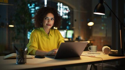 Poster - Motivated Arab Female Sitting in Creative Agency in the Evening, Manager Working on Implementing Business Strategy for Client. Excited Specialist Writing Corporate Project Plans on Laptop Computer.