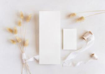 Wall Mural - Blank cards near silk ribbons and dried hare's tail grass top view on white, boho mockup