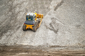 excavator, big yellow construction tractor at a construction site in a quarry. industrial image.