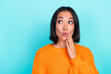 Sticker - Photo of impressed girl with bob hairdo dressed orange pullover look empty space palm on cheek isolated on turquoise color background