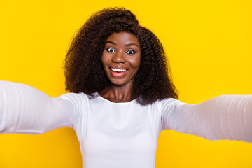 Wall Mural - Portrait of excited cheerful person make selfie record video beaming smile isolated on yellow color background