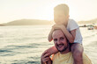 © Jelena Stanojkovic - Shot of a joyful father and daugther on the beach. Portrait of a happy father and son spending time together at the beach.