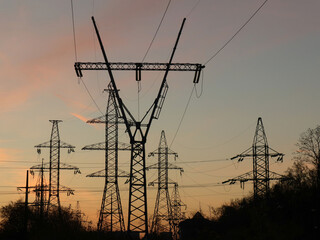 High-voltage power lines at sunset