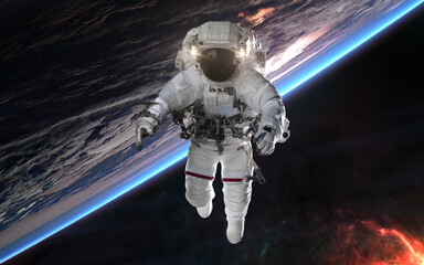 Wall Mural - astronaut in outer space orbiting earth. solar system. science fiction. elements of this image furni