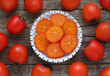 Slices of persimmon fruit in a bowl on a wooden background. Top view. Directly above photo.