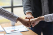 © crizzystudio - Businessman or partner in Asia team businessmen clenching fists After completing the agreement in the office collaborative work of colleagues team work concept