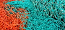 Fishing Net Background With Three Nets Orange, Green And Green-white Speckled
