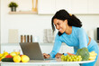 © Prostock-studio - Excited black woman in sportswear using laptop searching for information concern diet food, sitting in kitchen