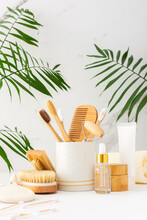 Wooden Toothbrushes With Natural Bristles In A Ceramic Glass, Face And Skin Care Products, Bottles With A Pipette And A Jar Of Cream, Bath Accessories, Spa And Beauty Concept