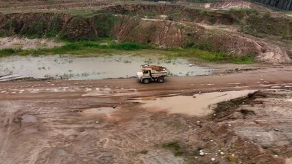 Poster - Mining truck transportation of loosened rock mass. Haulage and transportation of rocks in open-pit mine. Haul truck in sand quarry. Lorry in opencast. Bulk construction supplies in Mining industry.
