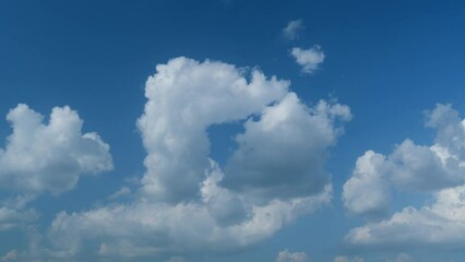 Wall Mural - Puffy fluffy white clouds. Forming cloud moving with blue sunny, summer skies. Timelapse.