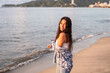 © Hector Pertuz - Latin woman posing at the beach during sunset.
