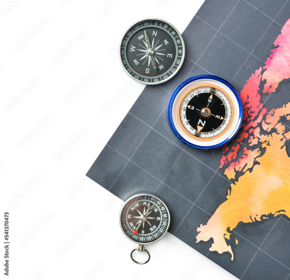 Vintage compasses and world map on white background, closeup