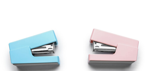 Two colorful staplers isolated on white background