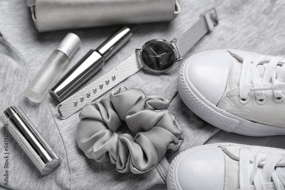 Female accessories and shoes on grey background, closeup