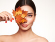 © Oleg Gekman - Portrait of beautiful young woman with autumn maple leafs. Healthy clean fresh skin natural make up beauty eyes and red nails