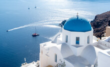 Blue-domed Greek Orthodox Church At Oia Town On Santorini Island