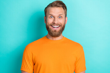 Poster - Photo portrait of nice young man smiling impressed astonished news discount wear trendy orange outfit isolated on cyan color background