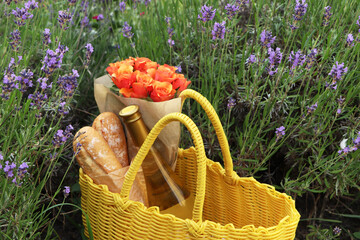 Canvas Print - Yellow wicker bag with beautiful roses, bottle of wine and baguettes in lavender field