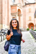 © Striker777 - Beautiful smiling  tourist Woman on the street in  Bologna . Concept of Italian gastronomy and travel.  Casual woman   taking a photo