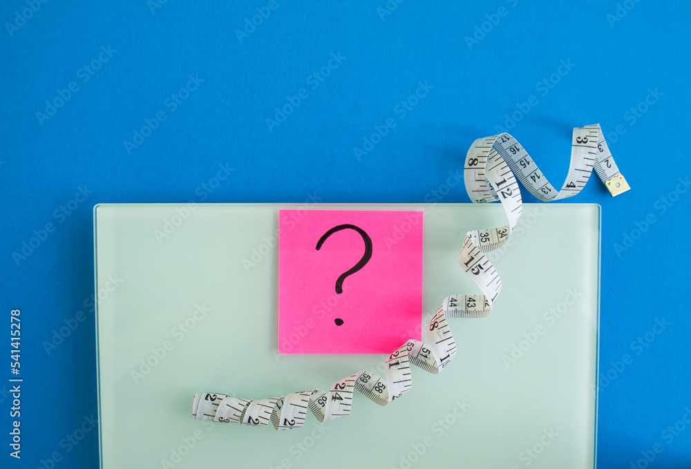 Digital Scale Sticker Electronic scales, a sticker with a question mark and a centimeter tape ...