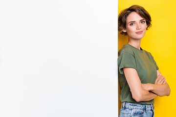 Sticker - Photo of adorable lady calm serious face stand empty space dressed khaki stylish clothes isolated on yellow color background