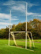 © mark_gusev - Small size tall goal post for training rugby, camogie, hurling, Gaelic football. Pitch for Irish National sport practice. Warm sunny day, Blue cloudy sky. Sport equipment in a field. Vertical image.