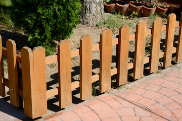 Sticker - Small wooden fence near thuja on sunny day outdoors