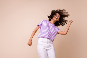 Wall Mural - Photo of pretty funky lady wear violet t-shirt having fun dancing empty space isolated beige color background