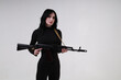 © Сергей Луговский - Beautiful slender brunette woman in black clothes with assault rifle