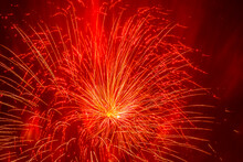 Oliday Background: Yellow Fireworks Against Red Smoke