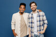 © ViDi Studio - Young two friends smiling happy fun cool cheerful men 20s wear white casual shirts together looking camera put hand on shoulder isolated plain dark royal navy blue background People lifestyle concept