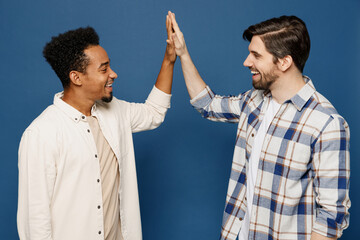 Wall Mural - Side view young two friends men wear white casual shirts meet together greeting giving high five clapping hands folded together isolated plain dark royal navy blue background People lifestyle concept