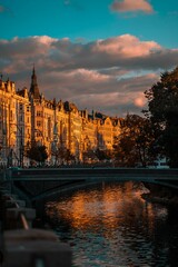 Canvas Print - Vertical shot of the beautiful buildings on the bank of the river. Prague, Czech Republic.