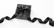 © Rawf8 - Black Friday Sale and Christmas present. Gift box with black ribbon isolated on white.
