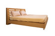 Wooden bed with light brown bedding.